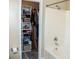 The bathroom features a shower-tub combo and is enhanced by organized closet shelving at 203 Goldfinch Ln, Summerville, SC 29485