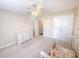 Neutral bedroom with a ceiling fan, white closet doors and dresser, and a partial view of a white crib at 203 Goldfinch Ln, Summerville, SC 29485