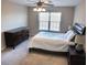 This bedroom is bright with a large window, and features a ceiling fan, a dresser, and nightstands at 203 Goldfinch Ln, Summerville, SC 29485