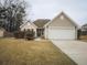 Charming single-Gathering home featuring a well-maintained front yard and an attached two-car garage at 203 Goldfinch Ln, Summerville, SC 29485