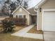 Close-up of a home's welcoming entrance, showcasing neat landscaping and a charming covered entry at 203 Goldfinch Ln, Summerville, SC 29485