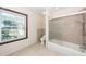 Bright bathroom featuring a shower-tub combination with glass doors and a large window at 210 Lakeview Dr, Summerville, SC 29485