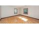 Bedroom featuring parquet floors, white walls, and natural light streaming through two windows at 210 Lakeview Dr, Summerville, SC 29485