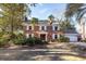 Charming brick home featuring a manicured lawn, and an attached garage on a sunny day at 210 Lakeview Dr, Summerville, SC 29485