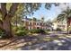 Charming two-story brick home featuring white shutters, a well-manicured lawn, and mature trees at 210 Lakeview Dr, Summerville, SC 29485