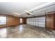 Spacious garage with wood paneling, a concrete floor, and an automatic garage door at 210 Lakeview Dr, Summerville, SC 29485