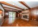 Living room features a brick fireplace, wood beam ceiling, and access to deck at 210 Lakeview Dr, Summerville, SC 29485