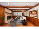 Inviting living room features a brick fireplace, wood paneling, and exposed beam ceiling at 210 Lakeview Dr, Summerville, SC 29485