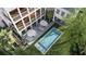 Aerial view of the home featuring a pool, outdoor seating, balconies and lush landscaping at 217 King George St, Daniel Island, SC 29492