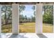 View of the backyard from the patio, showcasing trees and a scenic waterfront at 217 King George St, Daniel Island, SC 29492