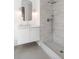Contemporary bathroom with a sleek white vanity and glass-enclosed shower with white tiled walls at 217 King George St, Daniel Island, SC 29492