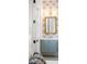 Charming powder room with blue vanity, palm-leaf wallpaper, and decorative mirror at 217 King George St, Daniel Island, SC 29492