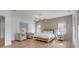 Bright bedroom with a king bed, side tables, two chairs, and a colorful art piece at 217 King George St, Daniel Island, SC 29492