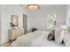 Sunlit bedroom boasts hardwood floors, natural decor, and ample natural light at 217 King George St, Daniel Island, SC 29492