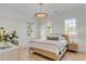 Cozy bedroom with a woven bed frame, three windows and hardwood floors at 217 King George St, Daniel Island, SC 29492