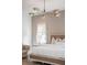 Stylish bedroom with a platform bed, modern chandelier, and large windows at 217 King George St, Daniel Island, SC 29492