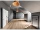 Open bonus room with gray walls, wood floors, built-in storage, and modern lighting at 217 King George St, Daniel Island, SC 29492