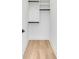 Walk-in closet with built-in shelving and hardwood floors at 217 King George St, Daniel Island, SC 29492