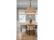 Elegant dining room featuring sophisticated wallpaper, a natural fiber pendant light, and a bright window view at 217 King George St, Daniel Island, SC 29492