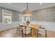 Elegant dining room featuring modern wallpaper, a large chandelier, and seating for four at 217 King George St, Daniel Island, SC 29492
