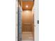 Interior view of a residential elevator featuring wood paneled walls and a safety gate at 217 King George St, Daniel Island, SC 29492