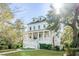 Beautiful white two-story home with a covered front porch and landscaped front yard at 217 King George St, Daniel Island, SC 29492