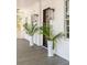 Inviting front porch with plants, classic lanterns, and wooden floors of the beautiful home at 217 King George St, Daniel Island, SC 29492