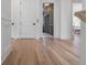 Bright hallway with wood floors leading to a kitchen and a bedroom at 217 King George St, Daniel Island, SC 29492
