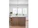 Kitchen island with wooden base, marble countertop, and bar seating creates a welcoming gathering space at 217 King George St, Daniel Island, SC 29492