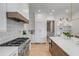 Spacious kitchen features white cabinets, stainless steel appliances, marble counters, and a kitchen island at 217 King George St, Daniel Island, SC 29492