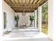 Covered patio with a dining table, chairs, large plants, and a view of the backyard at 217 King George St, Daniel Island, SC 29492