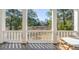 Scenic porch view with white railings, columns, and glimpses of the surrounding landscape at 217 King George St, Daniel Island, SC 29492