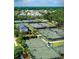 Aerial view of multiple tennis courts surrounded by trees and houses in this active community at 217 King George St, Daniel Island, SC 29492