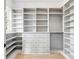 A large, custom walk-in closet with built-in shelving, drawers, and plenty of hanging space at 217 King George St, Daniel Island, SC 29492