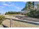 View of the backyard area with mature trees and a rustic fence surrounding the perimeter at 229 Celestial Blvd, Summerville, SC 29486