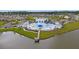 Aerial view of a community pool with a dock, pool-side buildings, and a lake, all nestled within a residential neighborhood at 229 Celestial Blvd, Summerville, SC 29486