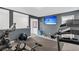 Well-equipped home gym features a mounted TV and workout equipment for a complete fitness experience at 229 Celestial Blvd, Summerville, SC 29486