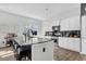 Beautiful kitchen island featuring bar stool seating, granite countertops, stainless appliances, and sleek white cabinets at 229 Celestial Blvd, Summerville, SC 29486