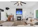 Cozy living room featuring a fireplace, TV, hardwood floors, and an open concept layout at 229 Celestial Blvd, Summerville, SC 29486