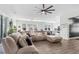 Spacious living room with hardwood floors, large sectional sofa, stylish ceiling fan, and an open floor plan at 229 Celestial Blvd, Summerville, SC 29486