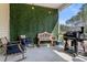 Cozy patio with comfortable rocking chairs, bench, grill, and privacy hedge at 229 Celestial Blvd, Summerville, SC 29486
