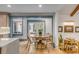 Bright dining area with a round table, seating for four, and natural light flowing through glass doors at 23 Edgewater Aly, Isle of Palms, SC 29451