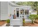 Inviting front porch with light blue accents, pineapple decor, and beautiful landscaping at 23 Edgewater Aly, Isle of Palms, SC 29451