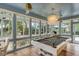 Game room featuring a pool table, elegant chandelier and views of the outdoor greenery at 23 Edgewater Aly, Isle of Palms, SC 29451