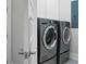 Modern laundry room featuring a side-by-side washer and dryer and white cabinetry at 2345 Primus Rd, Mount Pleasant, SC 29466