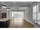 Bright, open-concept living room featuring hardwood floors, white trim and large windows at 2345 Primus Rd, Mount Pleasant, SC 29466