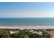 Aerial view of a beachfront property surrounded by lush greenery, showcasing the nearby ocean at 2473 Shipwatch Rd, Kiawah Island, SC 29455