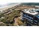 Breathtaking aerial view of the luxury condo complex and a beach, surrounded by lush vegetation at 2473 Shipwatch Rd, Kiawah Island, SC 29455