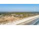 Luxury Sandcastle condo complex nestled among lush greenery and a pristine sandy beach by the ocean's edge at 2473 Shipwatch Rd, Kiawah Island, SC 29455