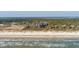 A luxury condo complex on a pristine beach is surrounded by mature trees, offering serene oceanfront living at 2473 Shipwatch Rd, Kiawah Island, SC 29455